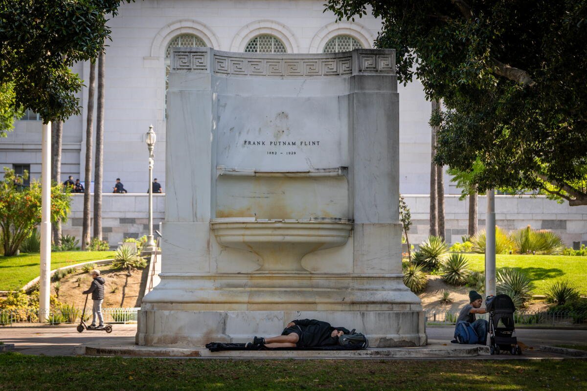 La gente dormía y descansaba en las fuentes a la sombra frente al Ayuntamiento.